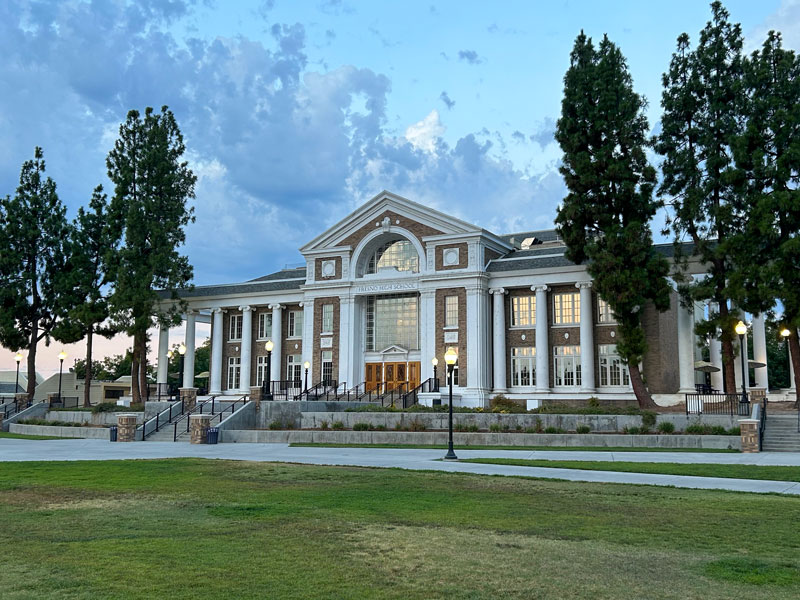 The main building of Fresno High School in Fresno, CA which features large and impressive columns in its architecture.